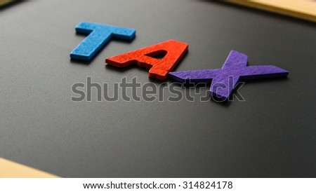 Alphabet TAX in black board