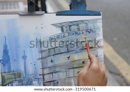 KUALA LUMPUR, MALAYSIA - 12TH APRIL 2015; Close up of artist\'s work at colonial style buildings or pre-war shop in Lebuh Pasar, at downtown street, in Kuala Lumpur, Malaysia.