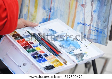 KUALA LUMPUR, MALAYSIA - 12TH APRIL 2015; Close up of artist\'s work at colonial style buildings or pre-war shop in Lebuh Pasar, at downtown street, in Kuala Lumpur, Malaysia.
