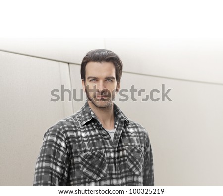 Portrait of a good looking guy against bright modern background with lots of copy space