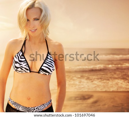Warm fashion portrait of a sexy smiling female bikini model at the beach with vintage feel
