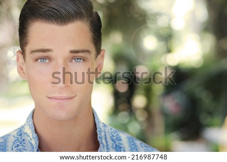 Close up natural portrait of a confident handsome young man