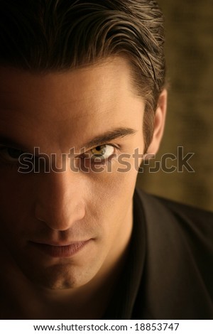 half face of a sinister young man with hair back