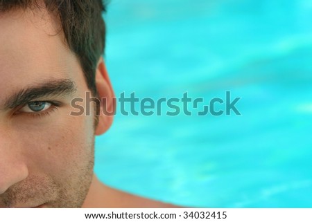 Close up of man\'s blue eye against blue background