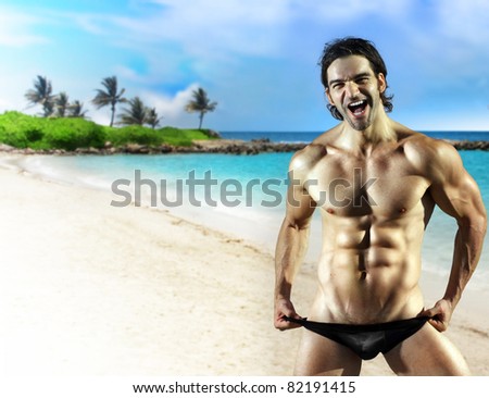 Sexy fun muscular male fitness model with big smile