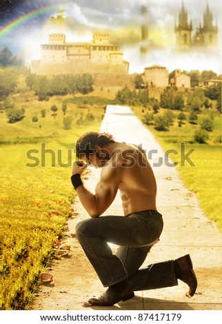 Conceptual portrait of a shirtless man kneeling with a dreamy fantastical background far behind