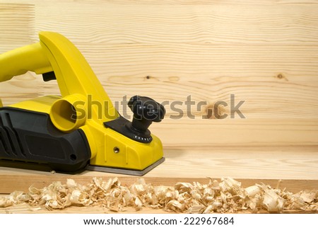 yellow electric plane on a board of wood
