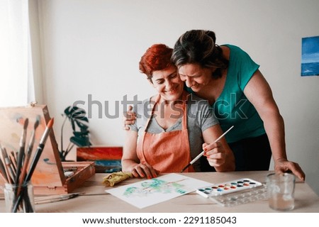 Image, Stock Photo happy lesbian couple painting the room walls with white color. Do it yourself and new home concept