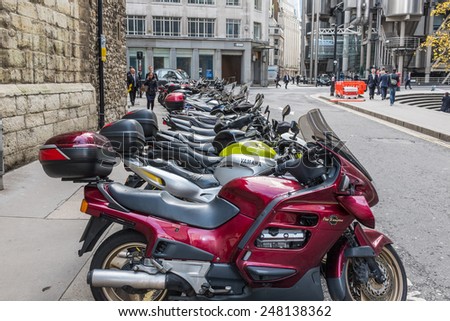 LONDON, UK - OCTOBER 21, 2013 : Motorcycles lined up and parked at St Mary Axe in the financial city of central London.