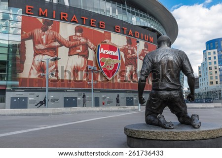 LONDON, UK - SEPTEMBER 24, 2014 : Arsenal Football Club Emirates Stadium in North London, England with club legend and all time record goal scorer Thierry Henry bronze statue.