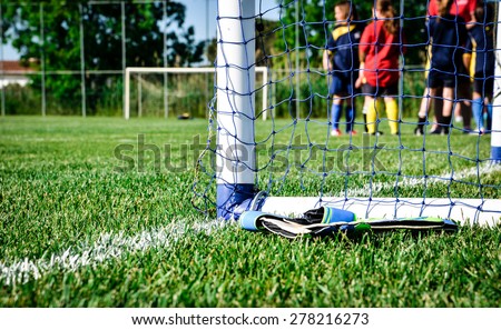 Goalpost detail: children waiting for the football match to start