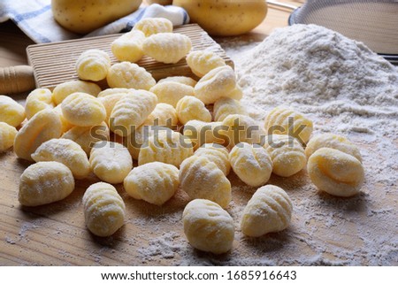 Similar – Image, Stock Photo Homemade gnocchi preparation on rustic kitchen table with ingredients. Top view. Potatoes dough . Italian food concept.