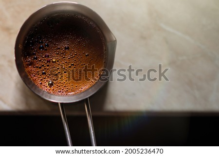 Similar – Image, Stock Photo Turkish espresso pot made of hammered metal stands for coffee preparation on the gas flame of the kitchen stove