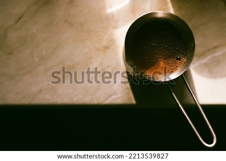 Similar – Image, Stock Photo Turkish espresso pot made of hammered metal stands for coffee preparation on the gas flame of the kitchen stove