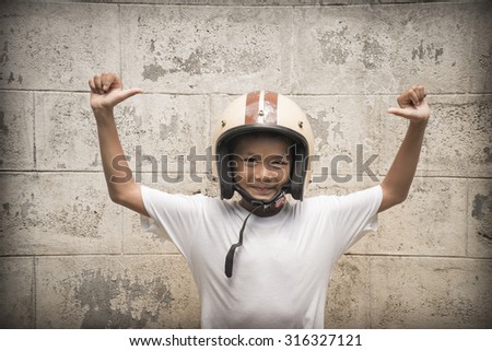 young boy wearing motorbike safety helmet