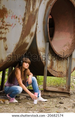 beauty girl with balloon paint sit in headphones near constructions