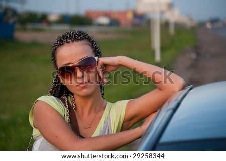 beauty white girl near car on roadside background