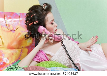 beauty girl pink phone call and look on her nails on color wall background