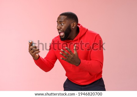 Desparate angry pissed african-american irritated man yelling smartphone look angry phone display gesturing dismay anger, furious lose last level hard game, standing bothered outraged Foto d'archivio © 