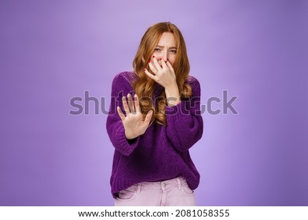 Oh gosh how stink take away, gross. Portrait of disgusted and displeased redhead woman pulling hand towards camera in rejection gesture while closing nose not smell awful reek squinting from aversion Stok fotoğraf © 