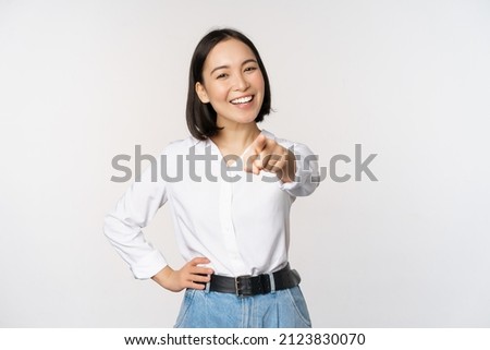 Similar – Image, Stock Photo Beautiful young confident Asian young girl posing  in front of colorful wall. Female tourist from China traveling in Europe. Exchange student. Fashion and style concept with Asian model.