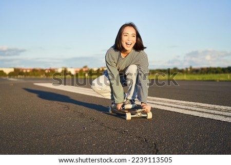 Similar – Image, Stock Photo Relaxed stylish skater riding skateboard along pavement