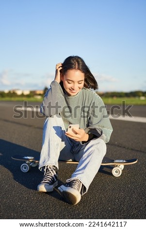 Similar – Image, Stock Photo Relaxed stylish skater riding skateboard along pavement