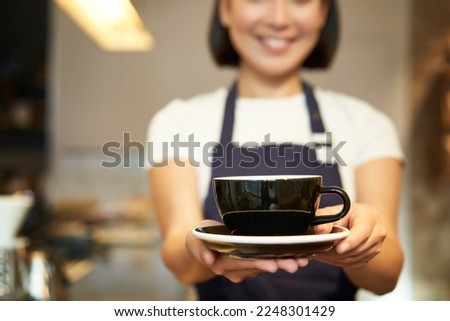 Similar – Image, Stock Photo Crop Asian waitress serving burger in cafe