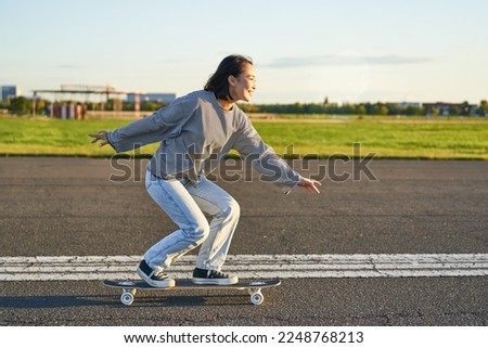 Similar – Image, Stock Photo Skaters sitting on empty rural road chatting in sunlight