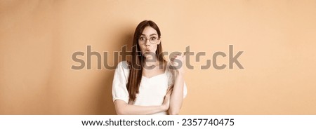 Similar – Image, Stock Photo A young woman says goodbye to an incredibly cuddly house cat. The cat enjoys the caresses in the sun on the stairs.