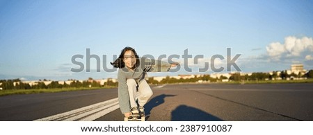 Similar – Image, Stock Photo Skaters sitting on empty rural road chatting in sunlight