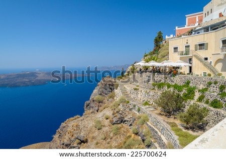 Santorini, Greece - August 13, 2013:Small tavern on cliff at Fira town, with beautiful view on caldera and volcano