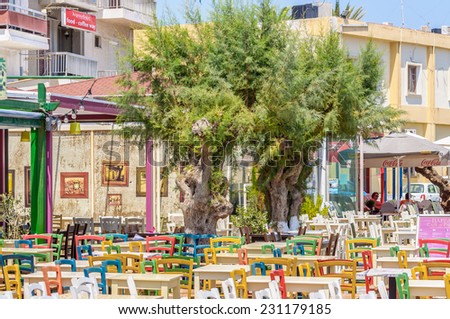 IERAPETRA, CRETE, GREECE - AUGUST 22, 2013: Color chairs and table in traditional Greek cafe at Ierapetra city.