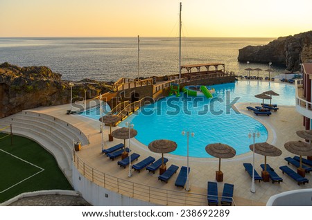 CRETE, GREECE - AUGUST 2013: Sunset view on beautiful swimming pool in Greek hotel on Crete island.