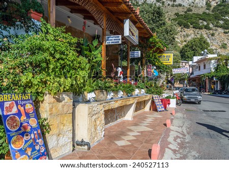 SPILI, CRETE, GREECE - AUGUST 20, 2013: Traditional Greek tavern, decorated with sculptures of lions in small town of Spili, located on Crete island.