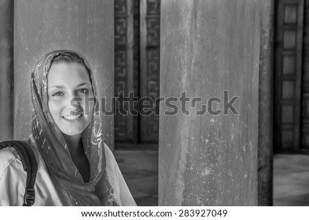 Beautiful young woman wearing kerchief in a mosque in Tunisia, in black and white