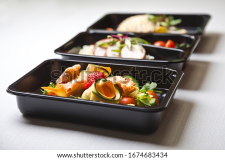 Catering food with healthy balanced diet delicious lunch box gastronomy boxed take away deliver packed ready meal in black container restaurant inn dinner, meal, brakfast ストックフォト © 
