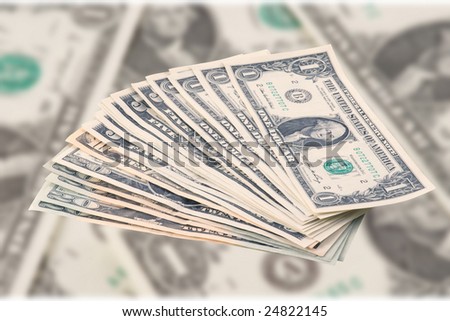 Pile of dollars on blur dollar\'s background