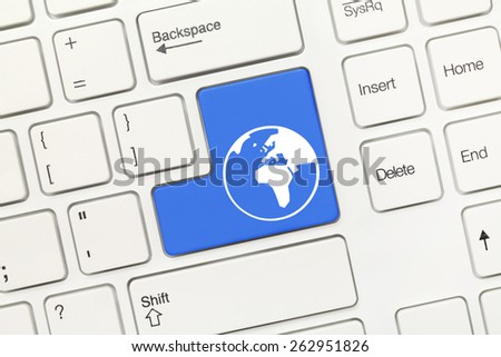 Close-up view on white conceptual keyboard - Blue key with world symbol