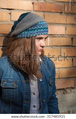 girl in a denim jacket and knit cap