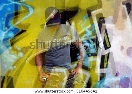 Graffiti Artist and graffiti on the wall at Meeting of styles international graffiti festival, Budapest, Hungary, 22 05, 2011.