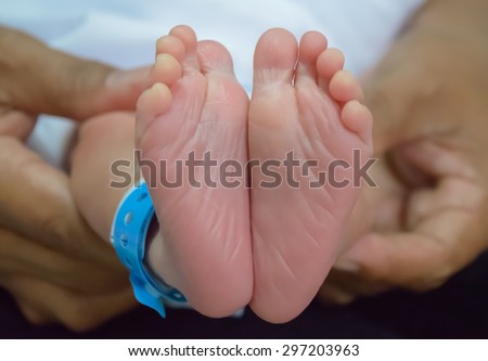 Baby feet of asian boy newborn.(close-up, blurred focus)