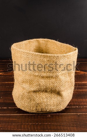 empty sack bag on wooden table,blank burlap bag