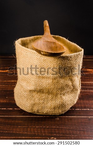 empty sack bag on wooden table,blank burlap bag with wooden spoon