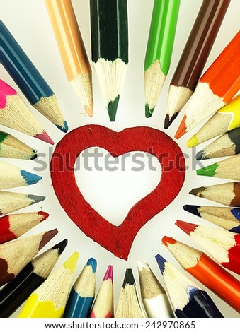 Wooden crayons and Heart. The visible spectrum of colors. Arranged in a circle.