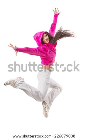 Young modern flexible hip-hop dance girl mid jump. Female in white sweatpants and a pink hoodie and sneakers standing on isolated white background.