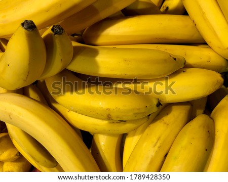 Macro photo food product yellow bananas. Stock photo Texture background tropical ripe fruit bananas. Natural useful banana peel.