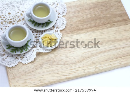 picture of cups of tea and snack with wood background