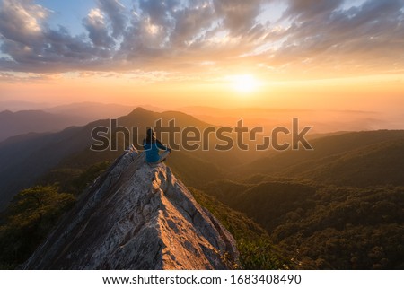 Meditation in great serenity at the top of a mountain rock in Taichung in Taiwan in front of the sun at sunset for great well being and wellness and energy Photo stock © 