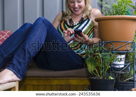 Woman sitting outside using smart phone